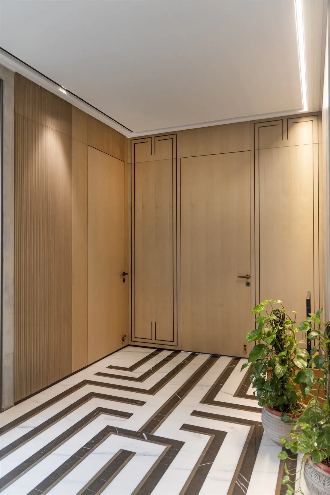 Oak-panelled vestibule with an inlaid marble floor
