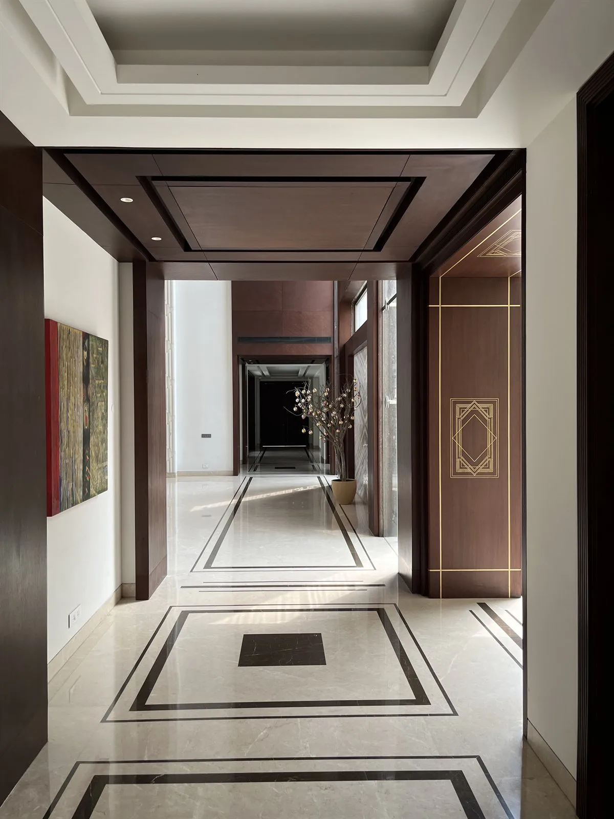 Timber-lined entrance vestibule with an inlaid marble floor