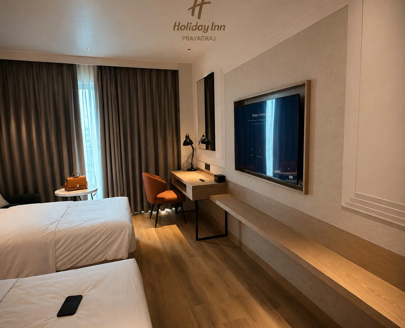 Twin guest room with desk run and panelled TV wall