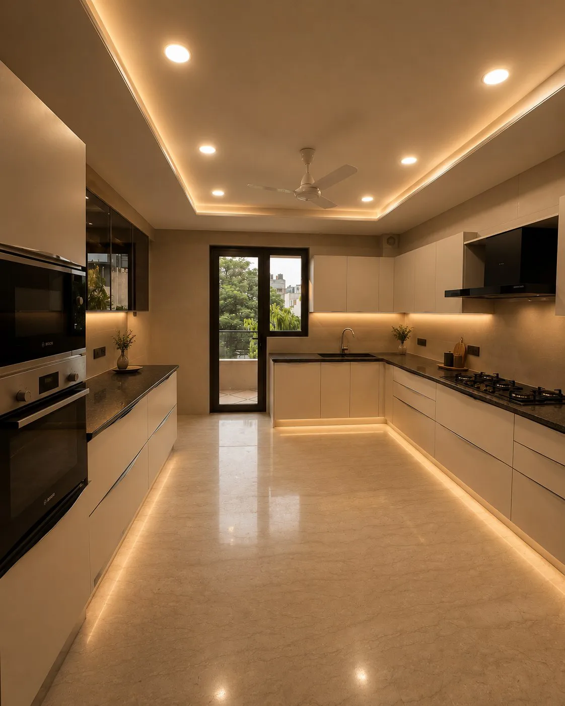 Galley kitchen in cream handleless units with a balcony door