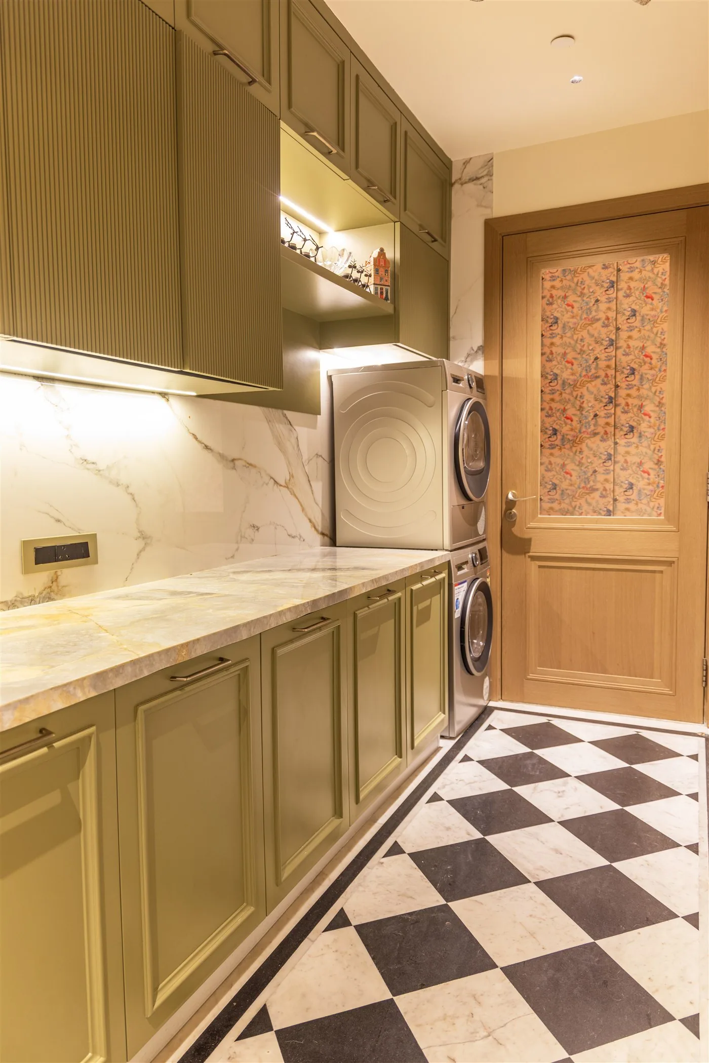 Utility room with fluted cabinetry and marble — 601, Camellias