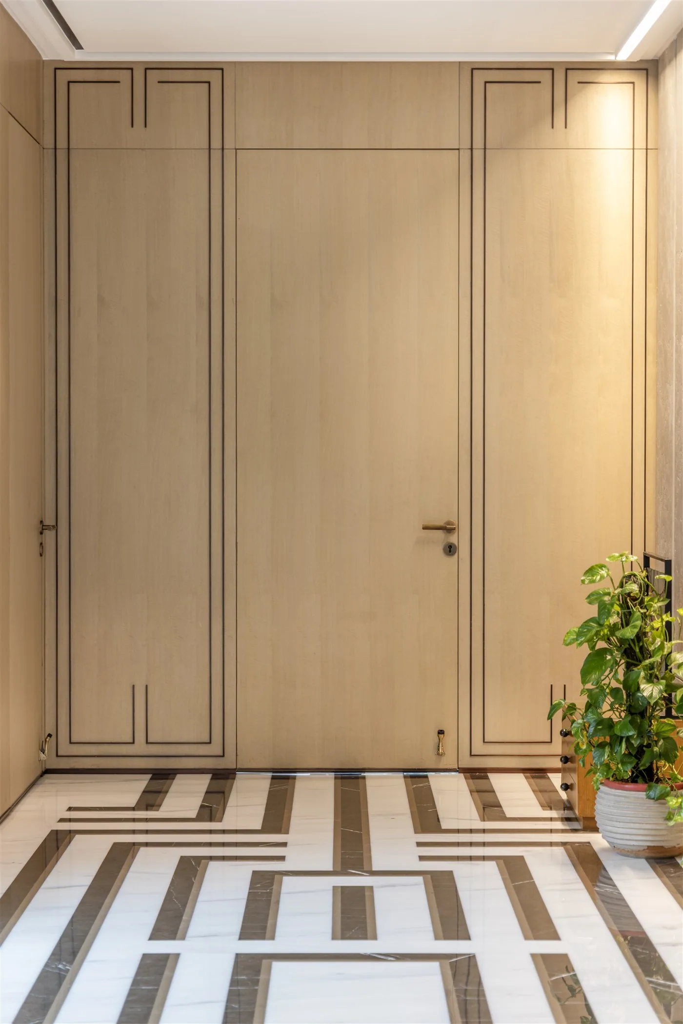 Panelled entrance doors with inlaid marble floor — Gulmohar Park