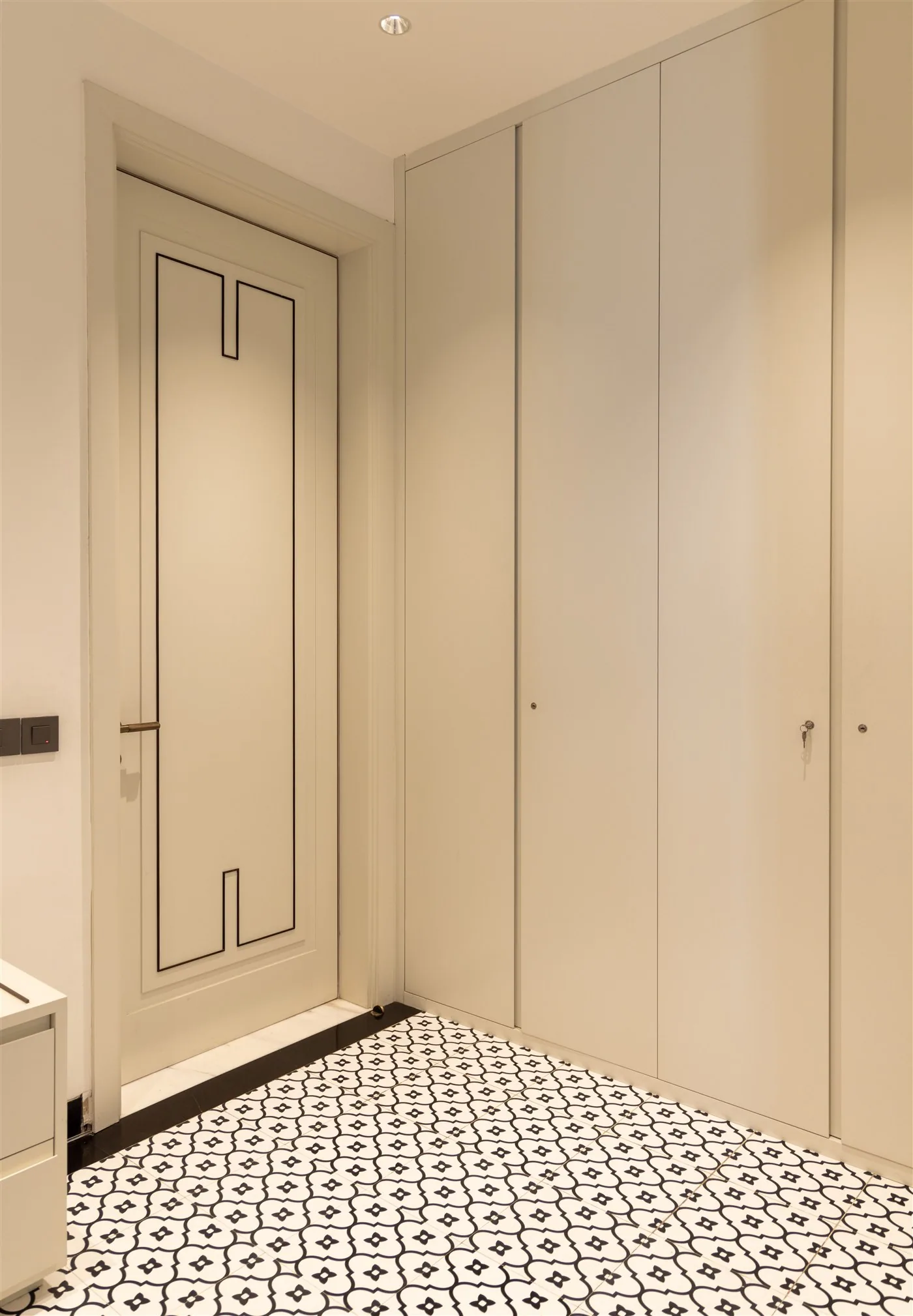Panelled door and full-height storage with patterned floor — Gulmohar Park