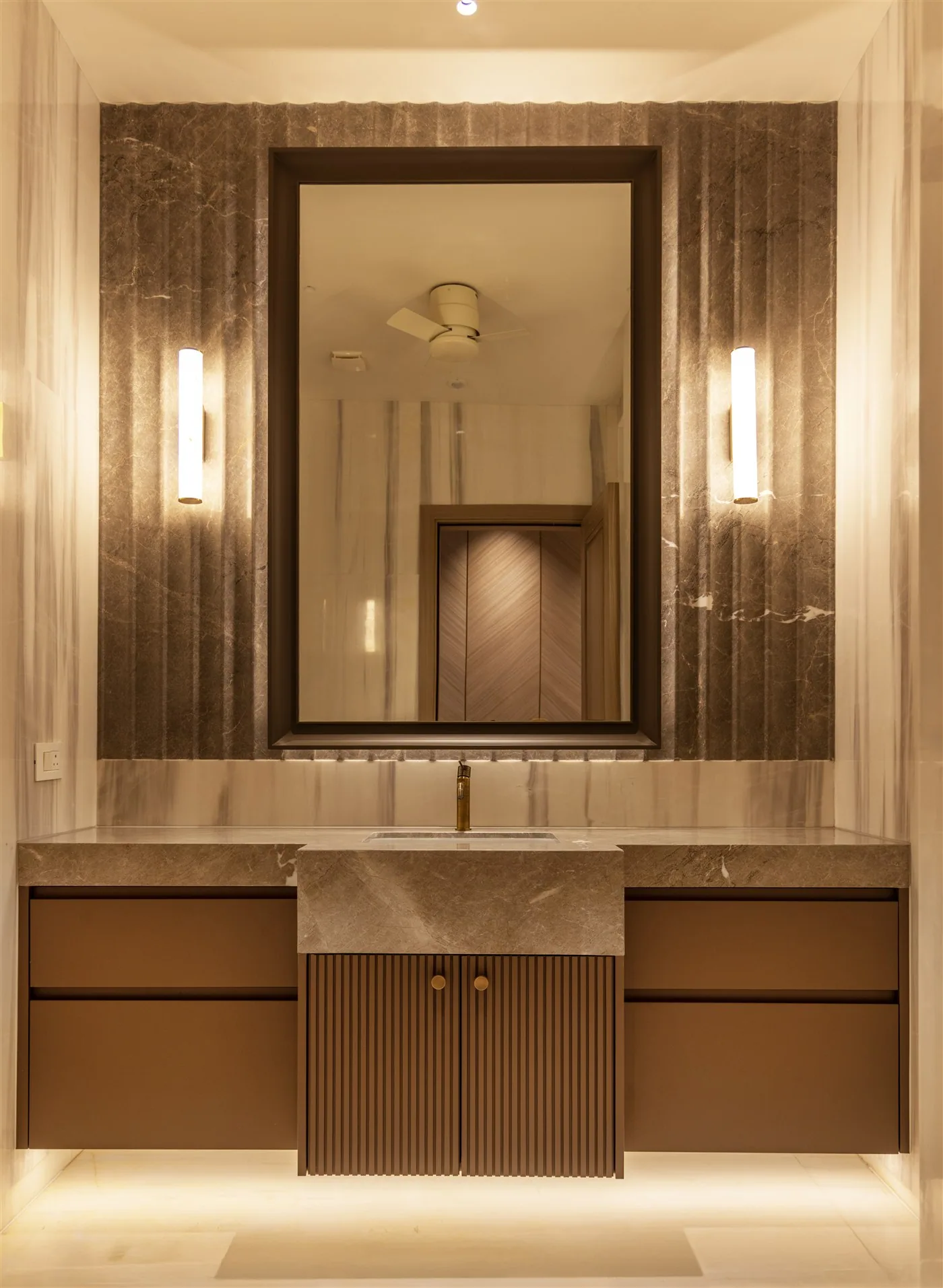 Vanity with stone-framed mirror and fluted doors — E-10/8 Vasant Vihar
