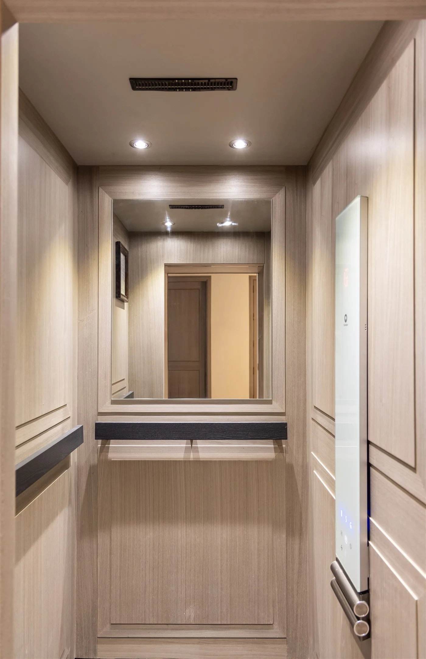 Lift interior lined in pale veneer — E-10/8 Vasant Vihar